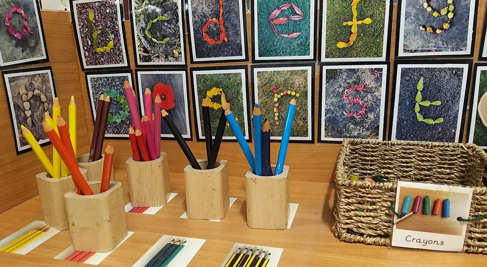 Pencils and crayons organised by colour in the Nursery mark making area