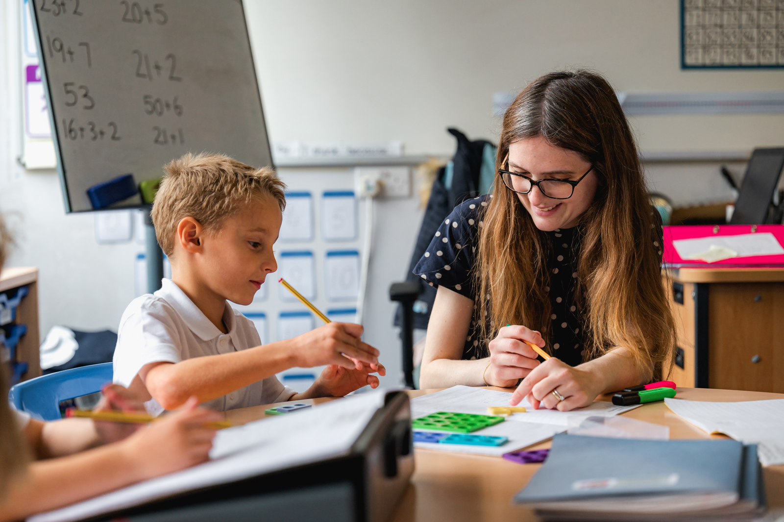 A teacher uses Numicon with a pupil during a maths lesson