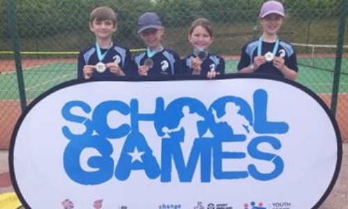 School Tennis team holding their medals at the Hertfordshire County Tennis finals